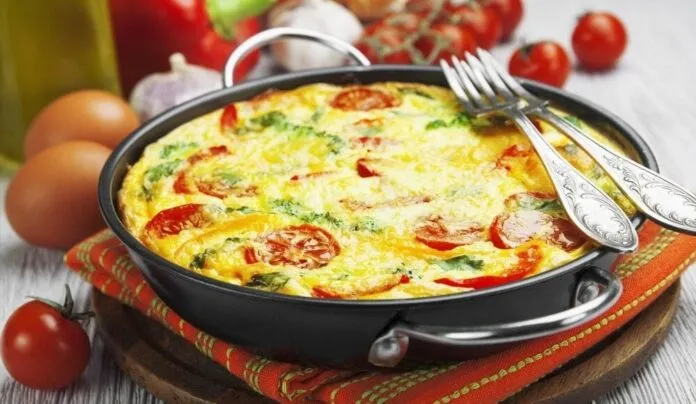 Omelete Low Carb com Legumes e Tomate Omelete low carb com legumes e tomate em frigideira preta.