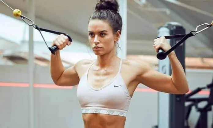 Mulher treinando com faixa de resistência Mulher fazendo exercício de resistência na academia.