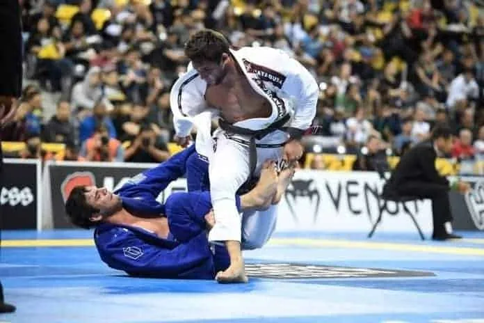 Luta de Jiu-Jitsu em Competição Atleta de Jiu-Jitsu em ação durante competição.